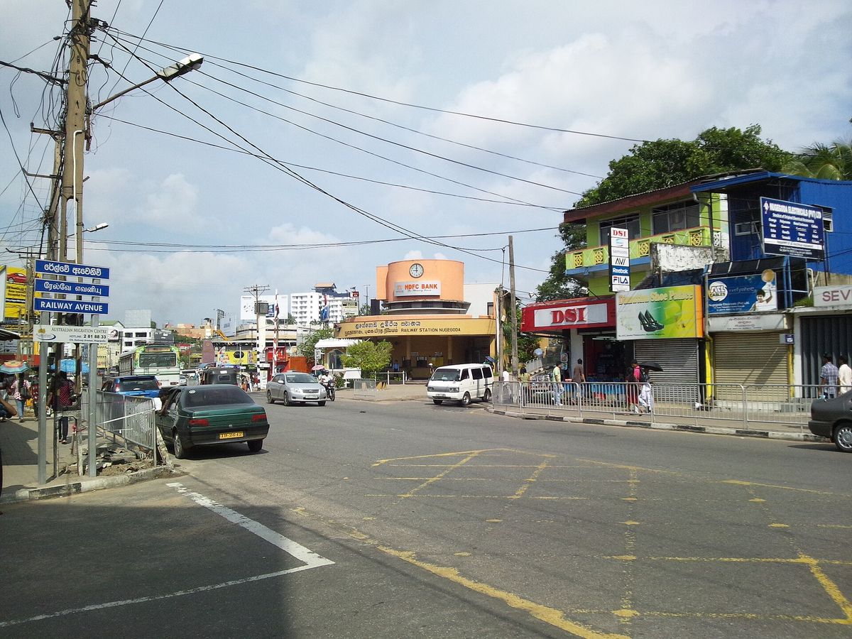 A busy junction in Nugegoda with shops and traffic